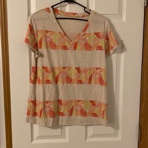 Tan / light pink shirt with leaves and strippes.